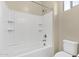 A bathroom featuring a white bathtub and toilet with white tiled walls at 3802 E Stiles Ln, Gilbert, AZ 85295