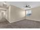 Spacious bedroom with carpeted flooring, neutral walls, fan, and bright natural light at 3802 E Stiles Ln, Gilbert, AZ 85295