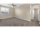 Spacious bedroom with carpeted flooring, neutral walls, fan, and bright natural light at 3802 E Stiles Ln, Gilbert, AZ 85295