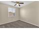 A cozy bedroom with neutral walls, carpet and a ceiling fan at 3802 E Stiles Ln, Gilbert, AZ 85295