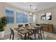 Bright dining room featuring a wooden table, contemporary lighting, and neutral tones for an inviting atmosphere at 3802 E Stiles Ln, Gilbert, AZ 85295