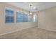 Bright dining room featuring large windows and stylish lighting fixture, offering ample space and natural light at 3802 E Stiles Ln, Gilbert, AZ 85295