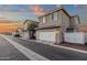 Charming two-story home with a well-maintained white garage door and beautiful sunset sky at 3802 E Stiles Ln, Gilbert, AZ 85295