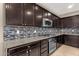 Gourmet kitchen features stainless steel appliances, granite countertops and backsplash at 3802 E Stiles Ln, Gilbert, AZ 85295