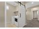 Tiled laundry room featuring a sliding barn door, washer and dryer at 3802 E Stiles Ln, Gilbert, AZ 85295