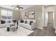 Bright living room with a white sofa, decorative pillows, and a stylish ceiling fan at 3802 E Stiles Ln, Gilbert, AZ 85295
