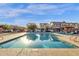 Community pool surrounded by lounge chairs with multiple residential units visible at 3802 E Stiles Ln, Gilbert, AZ 85295