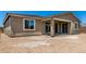 New construction backyard with covered patio and sliding glass doors ready for landscaping at 40563 W Michaels Dr, Maricopa, AZ 85138