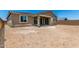Spacious backyard with covered patio and sliding glass doors offering great potential for outdoor living at 40563 W Michaels Dr, Maricopa, AZ 85138