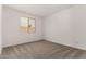 Bedroom featuring neutral carpet, white walls, and a view from a large window at 40563 W Michaels Dr, Maricopa, AZ 85138