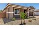 Charming front yard with desert landscaping and a small tree, enhancing curb appeal at 40563 W Michaels Dr, Maricopa, AZ 85138