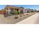 Well-maintained front yard with desert landscaping offering a welcoming entrance to the home at 40563 W Michaels Dr, Maricopa, AZ 85138