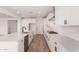 Open kitchen layout with sleek white cabinets, stainless appliances, and a functional island at 40563 W Michaels Dr, Maricopa, AZ 85138