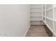 Walk-in pantry with adjustable white shelving, providing ample storage space at 40563 W Michaels Dr, Maricopa, AZ 85138