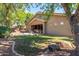 Spacious backyard featuring patio seating area, lush greenery, and rock details at 4192 E Carriage Way, Gilbert, AZ 85297