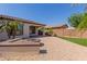 The backyard includes pavers, turf, a fire pit, and desert landscaping at 4481 N Luna W Rd, Litchfield Park, AZ 85340