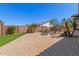 The backyard includes pavers, turf, a fire pit, block fence, and desert landscaping at 4481 N Luna W Rd, Litchfield Park, AZ 85340
