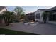 An outdoor fire pit with seating in a desert landscaped backyard adds a cozy touch at 4481 N Luna W Rd, Litchfield Park, AZ 85340