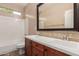 Bathroom features a double sink vanity with brown cabinets, backsplash, and a shower-tub combo at 4481 N Luna W Rd, Litchfield Park, AZ 85340