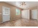 The spacious bedroom features neutral walls, tile floors, a ceiling fan and large wardrobe at 4481 N Luna W Rd, Litchfield Park, AZ 85340