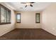 A clean and open bedroom features brown window shutters providing an airy feel and carpeted floors at 4481 N Luna W Rd, Litchfield Park, AZ 85340