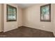 A carpeted bedroom with neutral walls is illuminated by windows and carpeted floors at 4481 N Luna W Rd, Litchfield Park, AZ 85340