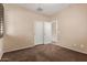 An empty bedroom showcases a closet, carpet flooring and a window for a cozy space at 4481 N Luna W Rd, Litchfield Park, AZ 85340