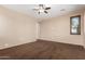 A neutral bedroom showcases a ceiling fan and a window, offering a blank canvas for personalization at 4481 N Luna W Rd, Litchfield Park, AZ 85340