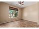 Bright bedroom featuring tile flooring, neutral walls, and a window to palms at 4481 N Luna W Rd, Litchfield Park, AZ 85340