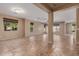 Spacious empty room featuring tile flooring, neutral walls, large windows, and an open floor plan at 4481 N Luna W Rd, Litchfield Park, AZ 85340