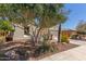 Charming home with desert landscaping, mature tree, and covered entry at 4481 N Luna W Rd, Litchfield Park, AZ 85340