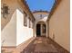 Inviting front entry with decorative pavers, a dark wood front door, and neutral-colored walls and trim at 4481 N Luna W Rd, Litchfield Park, AZ 85340