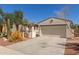 Single-Gathering home featuring desert landscaping, a gated entry, a two-car garage, and a well-maintained front yard at 4481 N Luna W Rd, Litchfield Park, AZ 85340