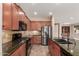 Well-equipped kitchen boasts granite countertops, stainless steel appliances, and wood cabinetry at 4481 N Luna W Rd, Litchfield Park, AZ 85340