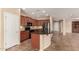 Modern kitchen with a center island, dark cabinets, and stainless steel appliances at 4481 N Luna W Rd, Litchfield Park, AZ 85340
