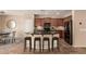 Modern kitchen with granite countertops, stainless steel appliances, an island with seating, and dark wood cabinets at 4481 N Luna W Rd, Litchfield Park, AZ 85340