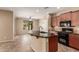 Kitchen with dark granite countertops, island and dark cabinets at 4481 N Luna W Rd, Litchfield Park, AZ 85340