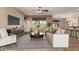Open living room with a large window, a ceiling fan, comfortable seating, and tile floors with a rug at 4481 N Luna W Rd, Litchfield Park, AZ 85340