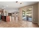 Open-concept living space with tile floors, island and patio access, perfect for entertaining at 4481 N Luna W Rd, Litchfield Park, AZ 85340