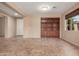Open floor plan with tile flooring, built in bookcase, and a bright window at 4481 N Luna W Rd, Litchfield Park, AZ 85340
