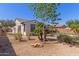 The front yard includes desert landscaping and lush trees at 4481 N Luna W Rd, Litchfield Park, AZ 85340