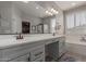 Bathroom with double vanity, large mirror, walk-in shower and separate soaking tub at 502 E Kona Dr, Casa Grande, AZ 85122