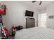 This bedroom shows mounted TV, ceiling fan, and decor for a great area to relax and unwind at 502 E Kona Dr, Casa Grande, AZ 85122