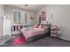 Bright bedroom featuring plantation shutters, plush pink rug, and charming decorative accents for a cozy atmosphere at 502 E Kona Dr, Casa Grande, AZ 85122