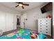 This bedroom offers ceiling fan, a closet, plush rug, and offers a serene space for relaxation and comfort at 502 E Kona Dr, Casa Grande, AZ 85122