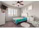 Inviting bedroom featuring plantation shutters, ceiling fan, and cozy decor for a comfortable and stylish retreat at 502 E Kona Dr, Casa Grande, AZ 85122