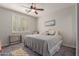 Bedroom featuring plantation shutters, ceiling fan, and cozy decor for a comfortable and stylish retreat at 502 E Kona Dr, Casa Grande, AZ 85122