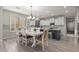 Open-concept kitchen and dining area with white cabinetry and modern appliances at 502 E Kona Dr, Casa Grande, AZ 85122