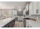Bright kitchen with stainless steel appliances, gray backsplash, and large center island with white countertop at 502 E Kona Dr, Casa Grande, AZ 85122