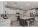 Spacious kitchen features white cabinets, stainless appliances, gray backsplash, and center island with seating at 502 E Kona Dr, Casa Grande, AZ 85122